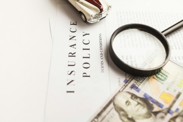 Certificate of motor insurance and policy with car and dollar bills